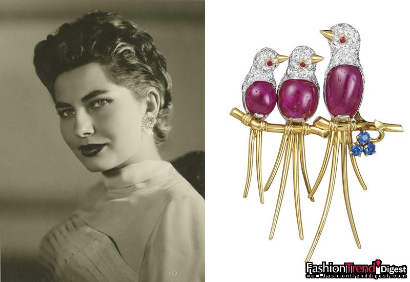 灵气之师：Lovebirds 胸针<br>
黄金、红宝石、蓝宝石及钻石，1954年<br>
<br>
曾是伊朗皇后苏瑞亚 (Princess Soraya of Iran) 的私人藏品。<br>
<br>
游走于现实与幻想中的动物国度，Van Cleef & Arpels 梵克雅宝撷取无穷创作灵感，将天堂鸟、鹫狮神兽、燕子、蝴蝶、蜻蜓、蜂鸟和它们优美的翅膀、羽毛幻化为灵动的典雅珠宝，尽情展现宝石鸟儿仿如翱翔空中的曼妙美态。<br>
<br>
Van Cleef & Arpels 梵克雅宝最柔丽的作品之一是象征温柔母爱的 Lovebird 胸针。它是当代优雅典范——苏瑞亚皇后(Soraya Esfandiari-Bakhtiari)的珍藏。苏瑞亚皇后雍容的美态和胜似绿宝石的深邃绿眸让世人为之倾倒。被她迷倒的还有伊朗国君，二人于1951年在德黑兰的Golestan Palace皇宫成婚，从此展开神仙美眷般的幸福生活。<br>
<br>
苏瑞亚于伊斯法罕长大，儿时常漫步于古典神秘的波斯花园，欣赏花卉和飞鸟的动人美态。她收藏的珠宝反映出她对大自然的钟爱。她于1954年购入的这枚彩色胸针，以拱形红宝石和圆形钻石勾勒出三只鸟儿栖息于黄金枝头的神态，树梢上更饰有一串蓝宝石花朵。<br>
<br>
Van Cleef & Arpels 梵克雅宝典藏 